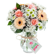 A radiant display of floral artistry echoes the spirit of Elephant and Castle in this joyful bouquet. Opening peach-pink roses centre the arrangement, their softness and gentle curves inviting the eye and heart alike. Two bold peach-orange gerbera daisies stand as beacons of warmth and lively optimism, offset by the dreamy clouds of baby's breath billowing between the larger blooms. White chrysanthemums, flecked with lively lime centers, add a cool, fresh note to the composition. Accents of eucalyptus, deep green and faintly aromatic, root the bouquet with an earthy calm. The whole creation is arranged in a clear glass vase, elegantly bulbous and subtly textured; inside, the mingled stems are visible in crystal water. At the vase neck, a rustic twine ribbon is knotted, holding a small, untouched white tag for a personalised greeting-ideal for sending brightness for any occasion. Whether gracing a home in Metro Central Heights or welcoming new neighbours in Walworth, this bouquet brings together community, colour, and loving intention from Elephant and Castle's own gifted florists.